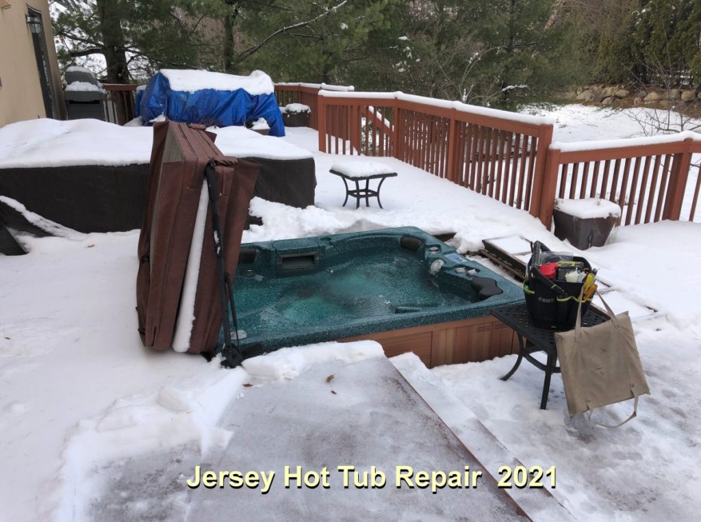 A hot tub, frozen in the snow